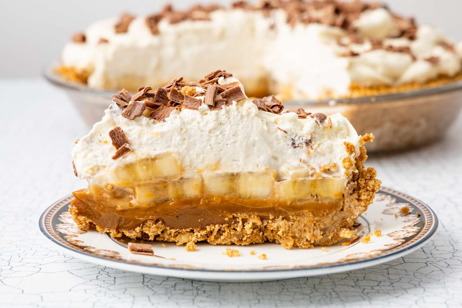 Slice of Banoffee Pie on a Small Plate, and in the Background, More Pie in a Pie Pan